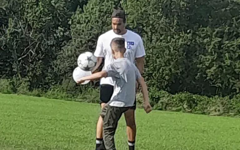 GYM Mentor playing football with mentee