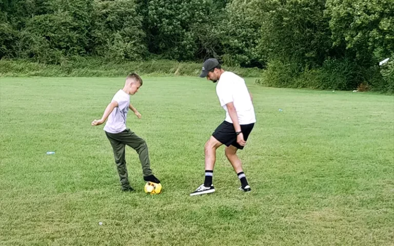 GYM Mentor playing football with mentee